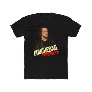 May include: Black t-shirt with a graphic of a man with long black hair wearing a leather jacket. The text "Douchebag Midget" is printed in yellow and red on the shirt.
