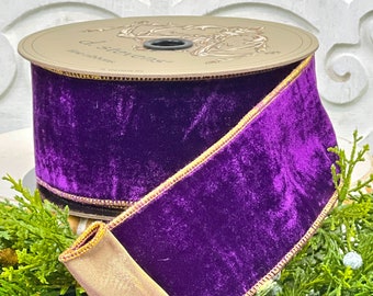 Op de afbeelding: Paarse fluwelen lint met een gouden rand. Het lint is op een spoel gerold met het label "d. sisters" erop.