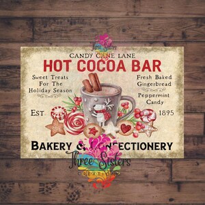 May include: A vintage-style sign for a Hot Cocoa Bar, featuring a mug of cocoa with a reindeer, gingerbread cookies, and candy canes. The sign includes text that reads "Candy Cane Lane" and "Bakery & Confectionery."