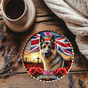 May include: A round coaster featuring a German Shepherd dog with a British flag background, poppies, and crosses. The coaster has the text "Lest We Forget" on a banner. The coaster is surrounded by a woven rope border.