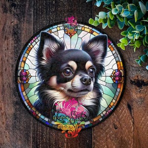 A circular metal decorative sign with A black and white chihuahua with brown eyes is depicted in a stained glass style illustration. The dog is surrounded by a colourful circular frame with floral designs