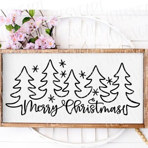 May include: A wooden sign with a white background and black lettering. The sign says "Merry Christmas" with a row of stylized Christmas trees and stars above the text.