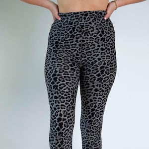 May include: Gray leggings with a black leopard print pattern.