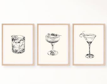 Puede incluir: Tres dibujos en blanco y negro de diferentes vasos de cóctel. El primer vaso es un vaso bajo con una rodaja de limón y una cereza. El segundo vaso es un vaso de martini con aceitunas en un pincho. El tercer vaso es un vaso de martini con una cáscara de limón.