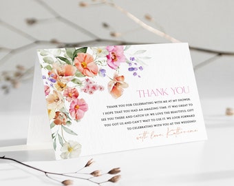 May include: A floral thank you card with a watercolor design of pink, orange, and yellow flowers. The text reads "Thank you for celebrating with me at my shower. I hope that you had an amazing time. It was great to see you there and catch up. We love the beautiful gift you got us and can't wait to use it. We look forward to celebrating with you at the wedding. With love, Katherine."