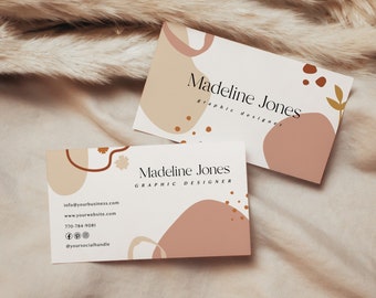 May include: Two business cards with an abstract design featuring brown, beige, and pink shapes. The text on the cards reads "Madeline Jones, Graphic Designer". The top card includes contact information: "info@yourbusiness.com, www.yourwebsite.com, 770-784-9081, @yoursocialhandle".