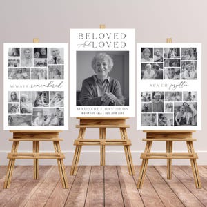 May include: Three wooden easels display memorial signs. The central sign reads "BELOVED and LOVED" above a portrait. The other signs feature photo collages with the phrases "ALWAYS remembered" and "NEVER forgotten".