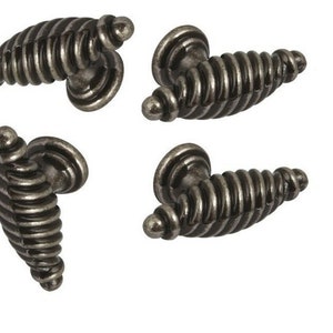 May include: Four antique silver cabinet knobs with a spiral design. The knobs are made of metal and have a tarnished finish.