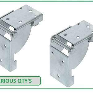 May include: Two silver folding hinges. Each hinge features a rectangular base with multiple screw holes, a pivoting arm, and a curved support. The text "VARIOUS QTY'S" is in a green box.