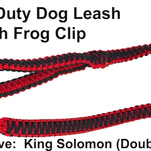 May include: A heavy-duty dog leash with a black and red King Solomon weave design. The leash features a frog clip for secure attachment. The text "Heavy Duty Dog Leash with Frog Clip" is visible.