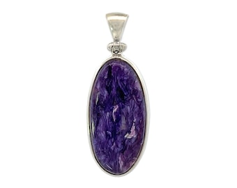 May include: A silver pendant featuring a large oval-shaped purple and pink stone. The stone has a swirling, marbled pattern.