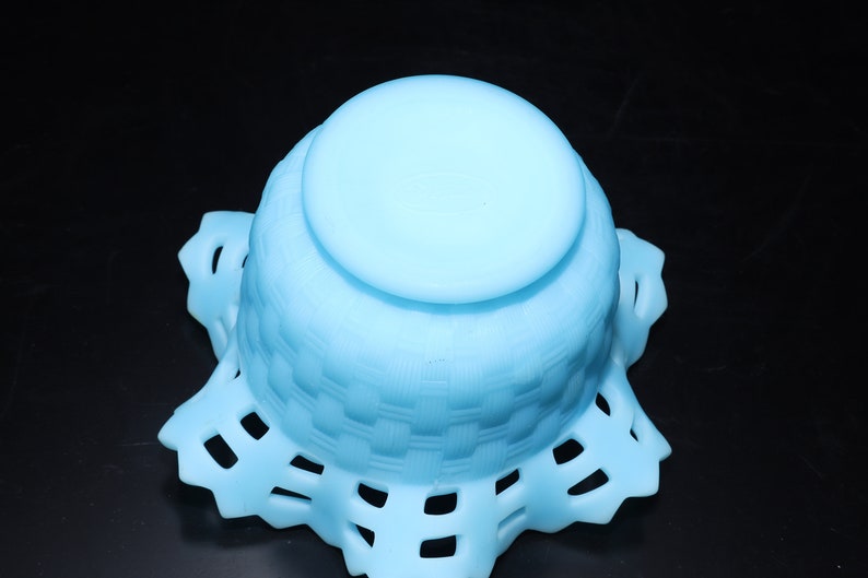 May include: A light blue glass bowl with a woven pattern and a scalloped edge.