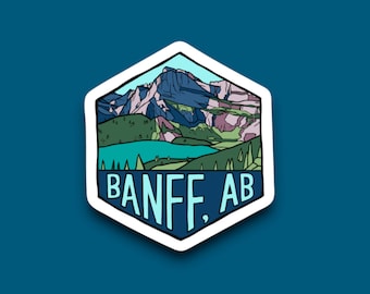 May include: A hexagonal sticker with a cartoon illustration of a mountain range and a lake. The text "BANFF, AB" is written in blue and white letters at the bottom of the sticker.