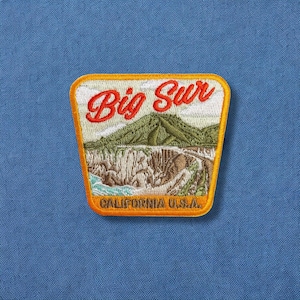 May include: Orange and yellow embroidered patch with the text "Big Sur California U.S.A." and a depiction of a mountain range.