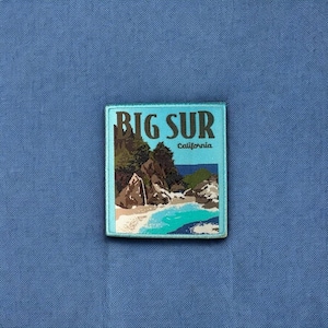 May include: A blue and brown patch with the text "BIG SUR California" and a scenic image of a rocky coastline with a waterfall and turquoise water.