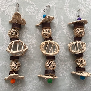 May include: Three natural woven bird toys with colorful beads. Each toy has a different design and is made with natural materials.