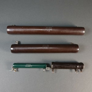 May include: Three brown ceramic resistors with metal end caps. The resistors are labeled with the text "2.2K OHMS", "1.00 OHMS", and "1.75 WATT".