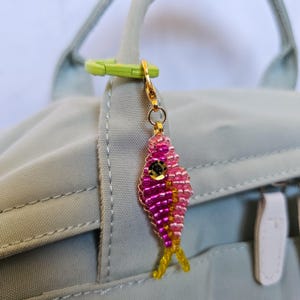 May include: A set of three ceramic mugs with a speckled, matte finish. The mugs are in shades of cream, light gray, and dark gray. Each mug has a simple, minimalist design and a rounded handle.