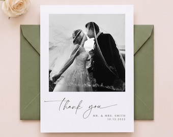 May include: A white rectangular thank you card featuring a black and white photograph of a couple kissing under a veil. The card includes the text Thank you, MR. & MRS. SMITH, and 10.12.2022 in black script and sans-serif fonts.
