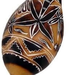 May include: A brown gourd with black and white geometric designs. The gourd is carved with a floral pattern and has a long, narrow neck.