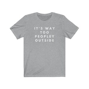 May include: A heather grey t-shirt with the text "IT'S WAY TOO PEOPLEY OUTSIDE" printed in white.