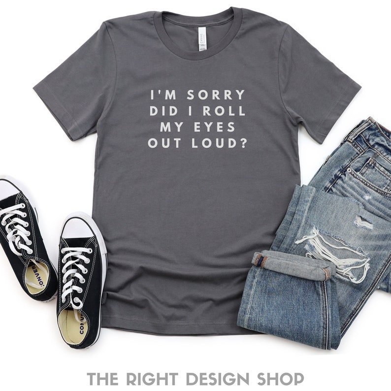 May include: A dark gray t-shirt with the text "I'm sorry did I roll my eyes out loud?" printed in white.