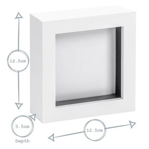 May include: White square shadow box frame with a 12.5 inch by 12.5 inch opening and a depth of 3.5 inches.