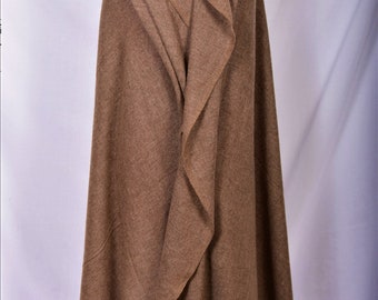 May include: A brown wool shawl draped over a mannequin. The shawl is folded to create a hood.