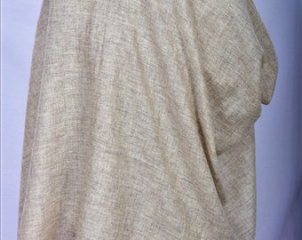 May include: A light beige shawl made of a soft, woven fabric. The shawl is draped over a mannequin and is folded in half.