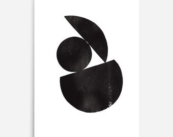 May include: A vertical rectangular print featuring three black ink-style geometric shapes on a white background. The composition includes a solid black circle, a black semicircle positioned below it, and a black curved segment placed at the top.