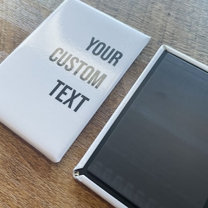 May include: A white rectangular magnet with the text "YOUR CUSTOM TEXT" printed in black.