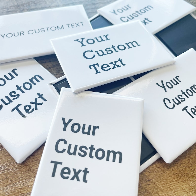 May include: A stack of white square magnets with black text that reads "Your Custom Text".