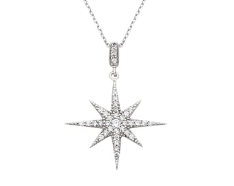 May include: A silver necklace featuring a star-shaped pendant set with clear cubic zirconia stones.