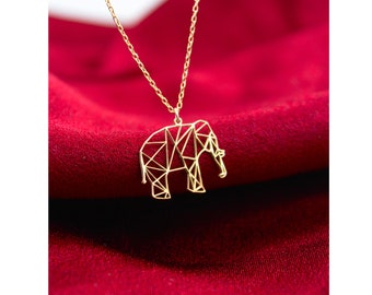 May include: A gold necklace with a geometric elephant pendant. The elephant is made of thin wire and has a delicate, intricate design.
