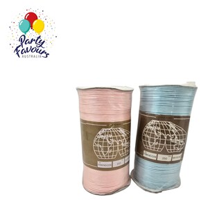May include: Two spools of cord, one pink and one light blue, are shown against a white backdrop. Each spool has a brown label with a world map graphic and the text "ITEM NO. COS 250". The cord appears to be made of a thin, woven material.