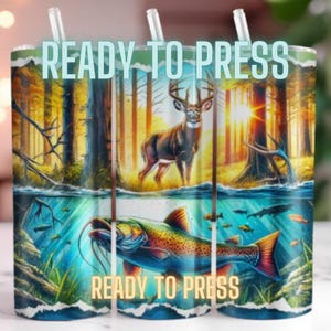 May include: Ready to press sublimation design featuring a deer in a forest setting with a fish in the water below. The design is perfect for creating custom tumblers, mugs, or other items.