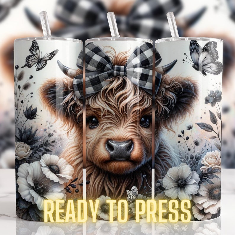 May include: A sublimation design featuring a Highland cow with a black and white checkered bow, surrounded by white and gray flowers and butterflies. The design is ready to be pressed onto a tumbler.