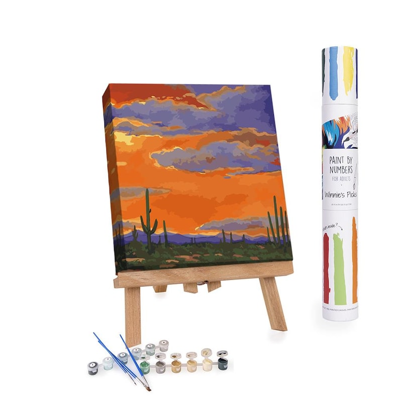 Saguaro Sunset Cactus Paint by Numbers Kit for Adults – a relaxing DIY painting kit featuring a desert sunset and saguaro cactus scene. Includes 16x16 inch linen canvas, pre-mixed acrylic paints, four brushes, and easy step-by-step instructions. Ideal for beginners, hobbyists, and those seeking creative home decor. A beautiful Southwestern art kit perfect for gifts, boho wall accents, or stress-relieving activities. Ships from New York in protective tube packaging.
