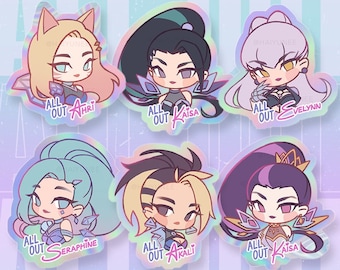 May include: Six 3-inch holographic stickers featuring K/DA band members Ahri, Kai'sa, Evelynn, Seraphine, Akali, and Kai'sa. Each sticker features a different character with a unique design and holographic finish.
