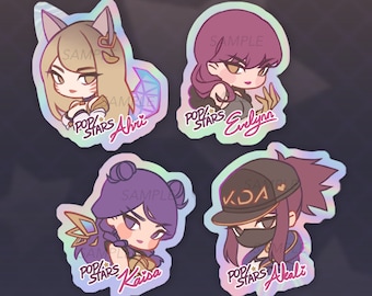 May include: Four holographic stickers featuring characters from the K/DA Pop/Stars music video. The stickers are 3 inches in diameter and feature the characters Ahri, Evelynn, Kai'sa, and Akali.