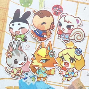 May include: Six colorful cartoon animal stickers with Japanese summer festival themes. The stickers feature a black and white rabbit, a brown bear, a white squirrel, a gray cat, an orange fox, and a yellow dog. Each animal is wearing a yukata and holding a summer treat like shaved ice, a popsicle, or a dango.