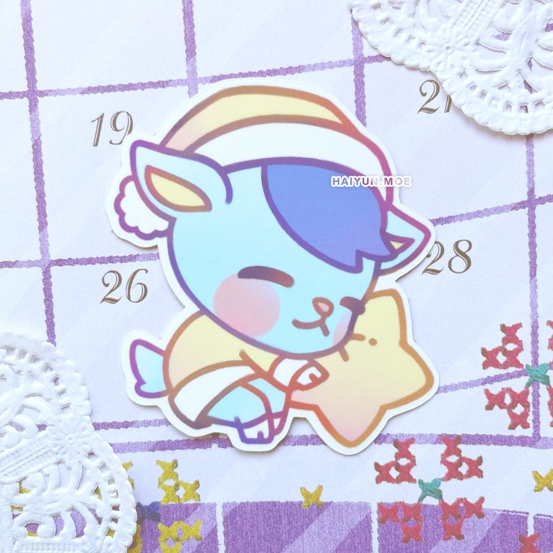 May include: A blue and purple cartoon animal wearing a yellow and white hat and holding a yellow star. The animal is wearing a yellow and white sweater. The image is on a purple and white background.