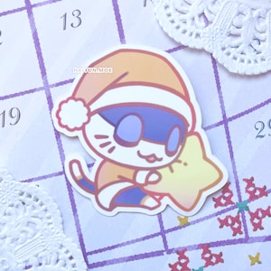 May include: A white cartoon cat wearing a red and orange Santa hat and holding a yellow star. The cat has blue eyes and a pink nose. The text "HAI YUN.MOE" is visible on the image.