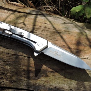 May include: A set of three ceramic mugs with a speckled, matte finish. The mugs are in shades of cream, light gray, and dark gray. Each mug has a simple, minimalist design and a rounded handle.