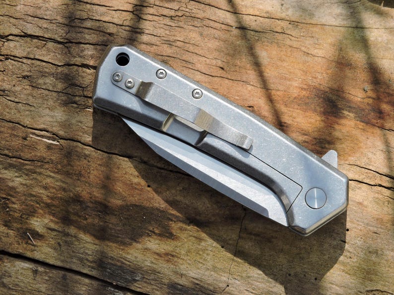 May include: A set of three ceramic mugs with a speckled, matte finish. The mugs are in shades of cream, light gray, and dark gray. Each mug has a simple, modern design and a rounded handle.