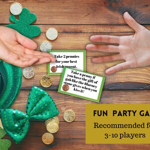 May include: A fun party game for 3-10 players with green shamrock cards and pennies. The cards have instructions for a game with an Irish theme. The text on the cards reads "Take 2 pennies for your best Irish accent." and "Take a penny if you have the gift of gab like the Blarney stone gives when you kiss it!"