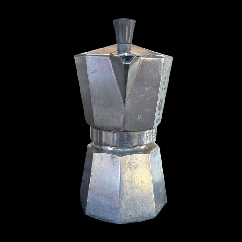 May include: A set of three ceramic mugs with a speckled, matte finish. Each mug features a different color: light blue, cream, and gray. The mugs have a simple, modern design and a comfortable handle.