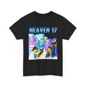 May include: Black t-shirt featuring a retro graphic with the text "HEAVEN 17" in blue. The graphic depicts a business scene with people in suits, a phone, and a cityscape background. A vintage-style design.