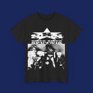 May include: Black t-shirt featuring a black and white image of a band with the text "Sigue Sigue Sputnik" and a star graphic. The band members are in a black and white photo. The shirt is on a blue background.