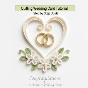 May include: A handmade wedding card with a heart-shaped design made of cream-colored paper. Two gold rings are inside the heart. The card features white paper flowers with green leaves and the text "Congratulations on Your Wedding Day."
